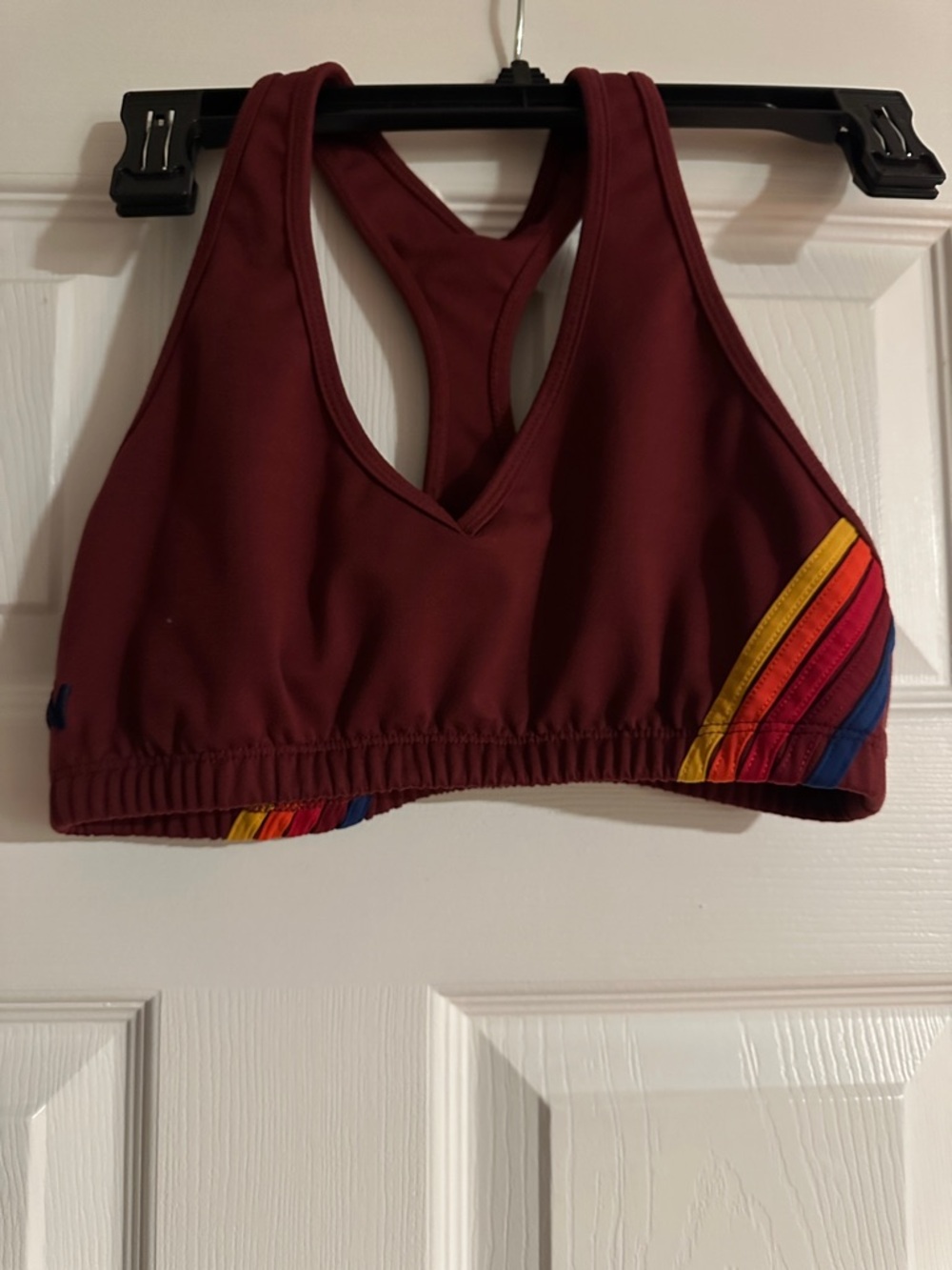 Aviator Nation Maroon Racerback Sports Bra with Rainbow Stripe Accents.